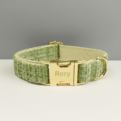 Green textured dog collar with gold buckle and 'Rory' engraving on a gray background