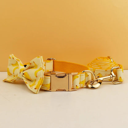 Dog collar, bow tie, and leash with banana pattern on a yellow background
