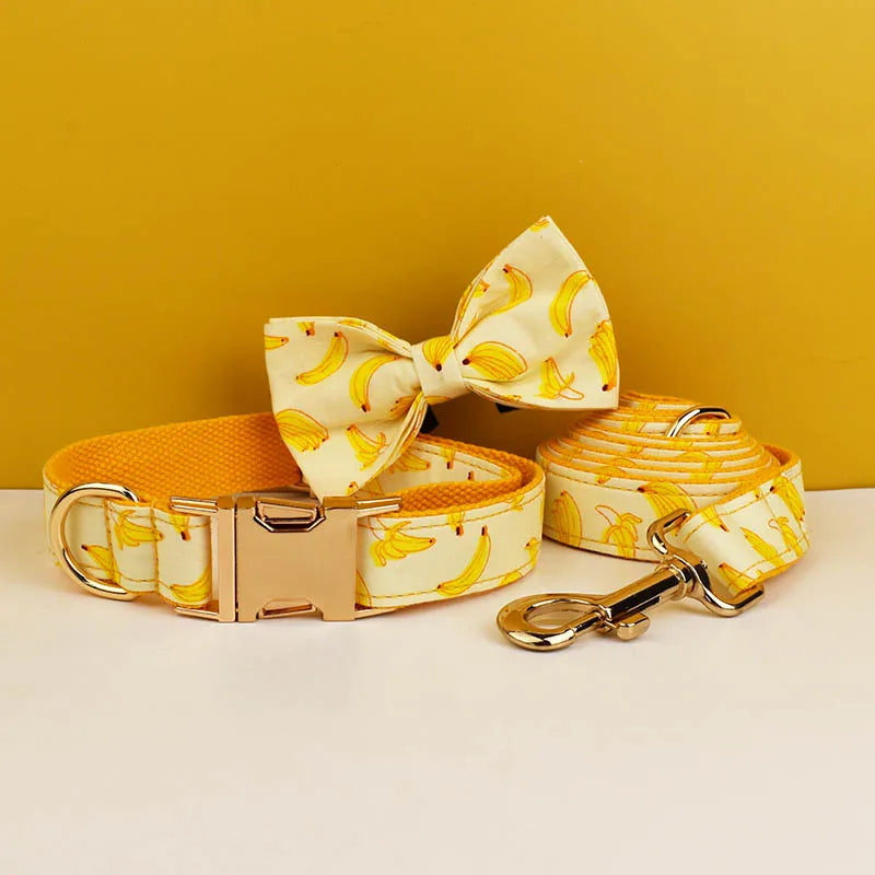 Dog collar, bow tie, and leash with banana pattern on a yellow background