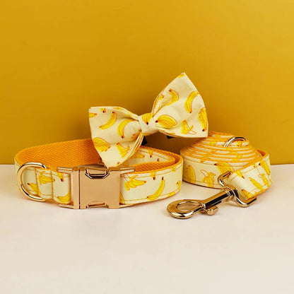 Dog collar, bow tie, and leash with banana pattern on a yellow background