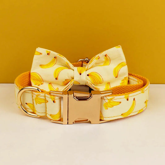 Dog collar with banana pattern and gold buckle on a yellow background