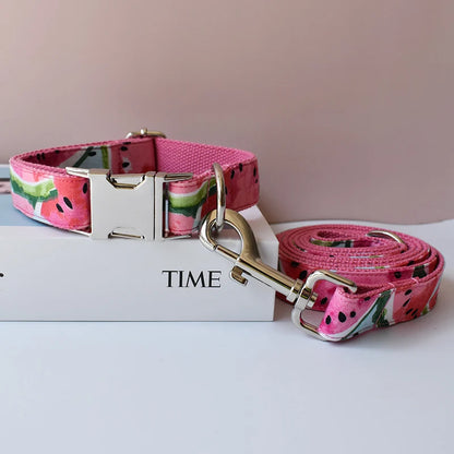 Pink watermelon-patterned dog collar and leash on a white surface with 'TIME' book.