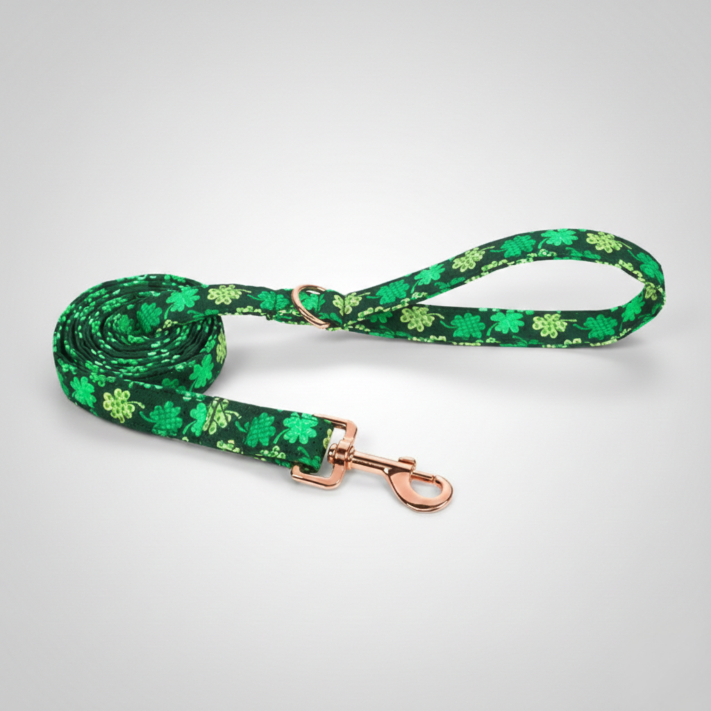 Green dog leash with shamrock pattern on a white background