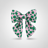 Large bow with green shamrock pattern on pink background