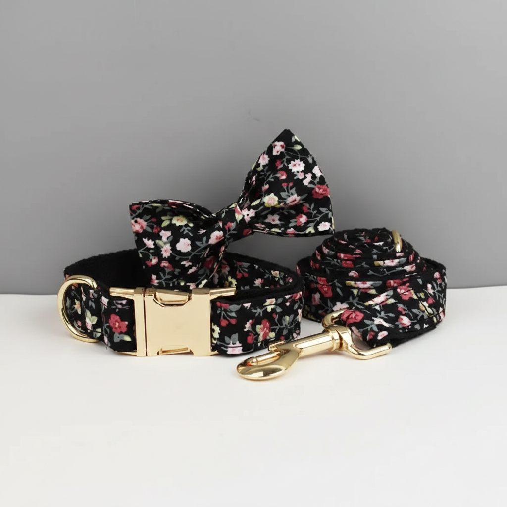 Floral-patterned dog collar, leash, and bow tie on a gray background