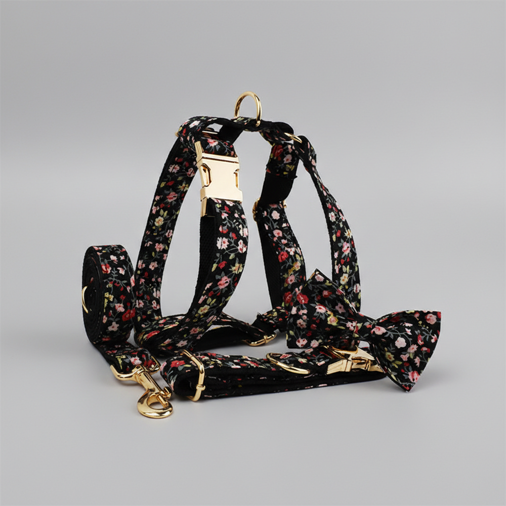 Floral-patterned dog collar, harness, leash, and bow tie on a gray background