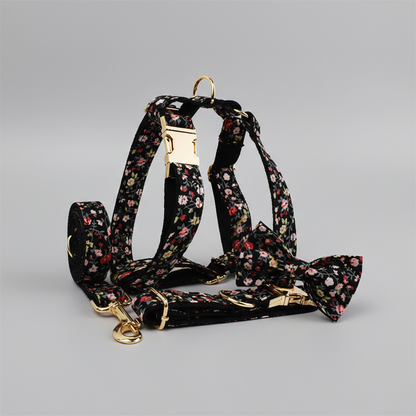 Floral-patterned dog collar, harness, leash, and bow tie on a gray background