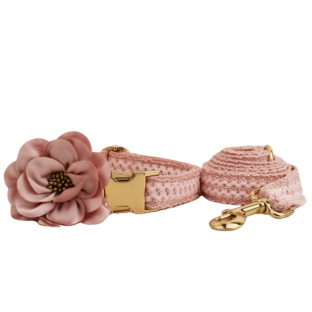 Pink floral dog collar and leash set on a white background