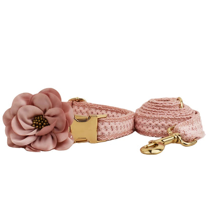 Pink floral dog collar and leash set on a white background