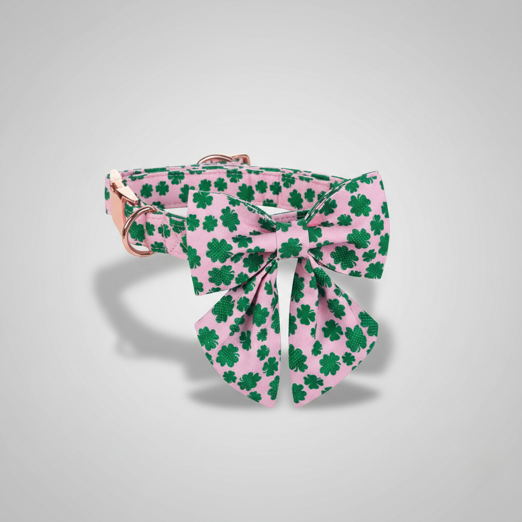 Pink hair bow with green shamrock pattern on a gray background