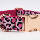 Dog collar with pink and black leopard print and rose gold buckle on a light gray background
