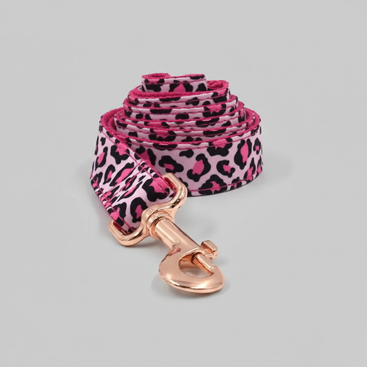 Pink leopard print dog leash with rose gold clasp on a light gray background