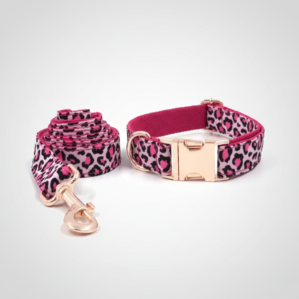 Pink leopard print dog collar and leash set on a light gray background