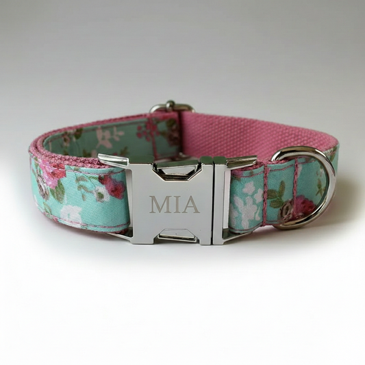 Floral-patterned dog collar with a silver buckle and 'MIA' engraving on a white background