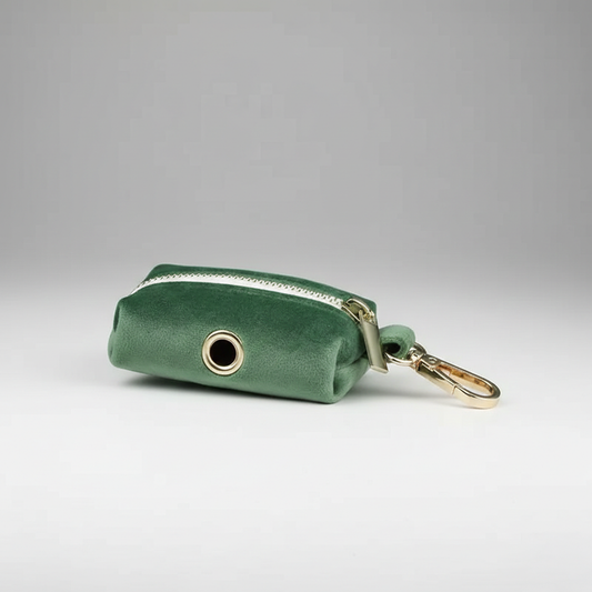Green keychain pouch with a gold ring on a gray background