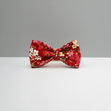 Red floral bow tie on a gray background