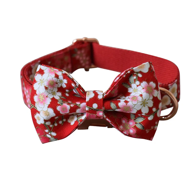 Red floral dog collar with a matching bow tie on a white background