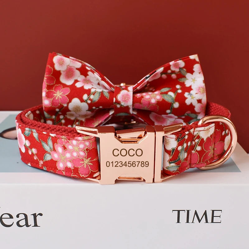 Floral dog collar with bow tie and engraved buckle on a red background