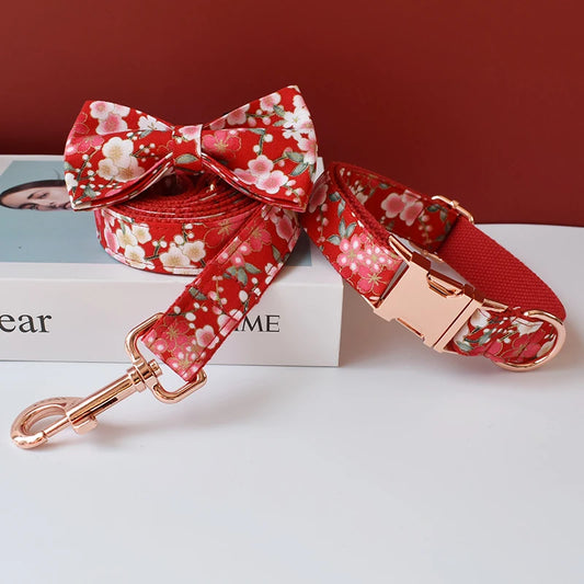 Red floral dog collar and leash set on a magazine with a red background