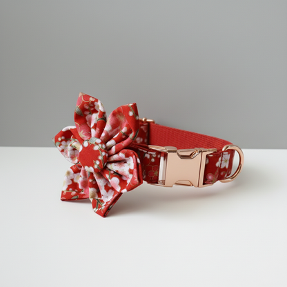 Red floral dog collar with a matching bow on a gray background