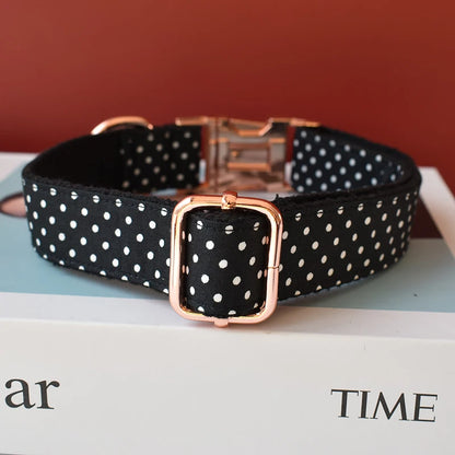 Black polka dot dog collar with rose gold buckle on a magazine