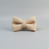 Beige bow tie on a gray background