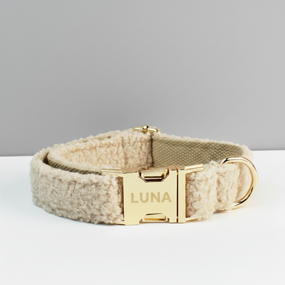 Beige dog collar with a gold buckle on a light gray background