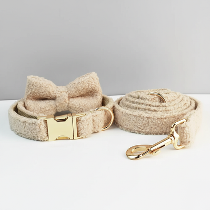 Dog collar with bow and matching leash on a light gray background